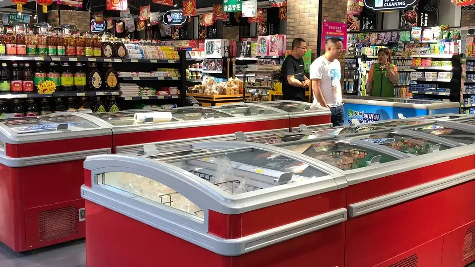 Commercial island freezers arranged in a supermarket frozen-food zone