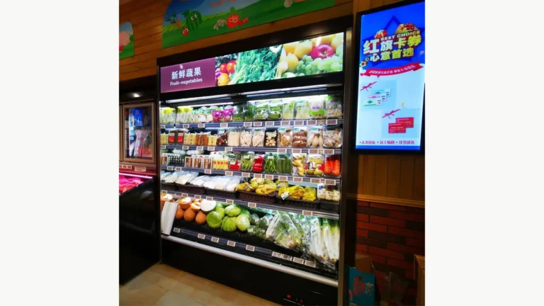 Plug-in multideck open chiller with a top light box displaying packaged produce